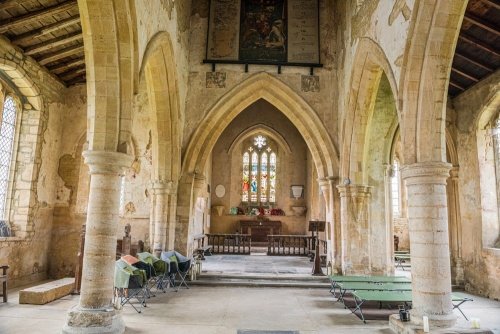 All Saints Church interior showing limestone arcades and the chancel arch